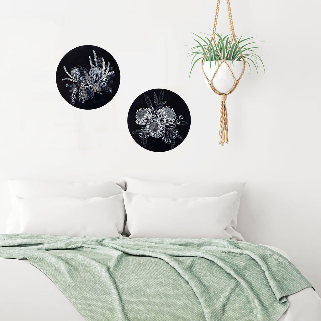 Coastal style Bedroom setting. Two blue and white Porthole paintings of Australian wildflowers on circular timber panels.